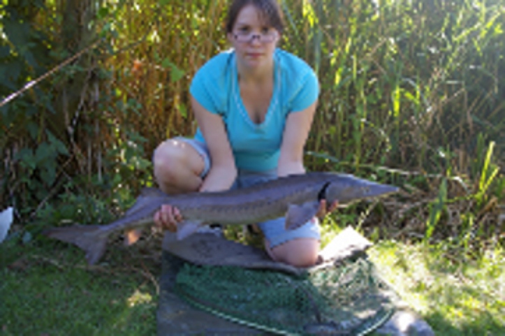 My daughter with a Sturgeon of 9 lbs